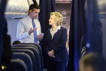 Democratic presidential nominee Hillary Clinton looks at a smart phone with national press