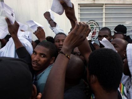 Haitian and African migrants seeking for asylum in the United States, push for a spot as they line up outside a Mexican Migration office, on October 3, 2016, in Tijuana, northwestern Mexico. / AFP / GUILLERMO ARIAS (Photo credit should read GUILLERMO ARIAS/AFP/Getty Images)