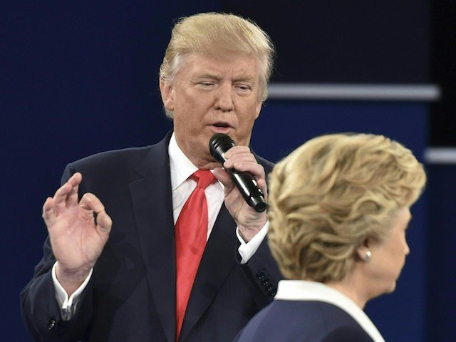 Republican presidential candidate Donald Trump speaks as Democratic presidential candidate Hillary Clinton walks past during the second presidential debate at Washington University in St. Louis, Missouri on October 9, 2016. / AFP / Paul J. Richards (Photo credit should read PAUL J. RICHARDS/AFP/Getty Images)