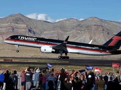 GRAND JUNCTION, CO - OCTOBER 18: Supporters cheer as the plane of Republican presidential