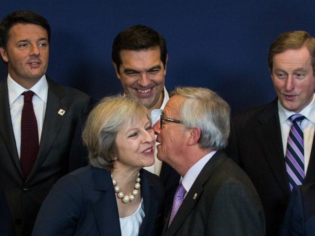 Theresa May kissing Jean-Claude Juncker
