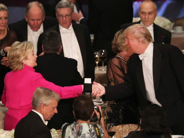 Hillary Clinton shakes hands with Donald Trump while attending the annual Alfred E. Smith