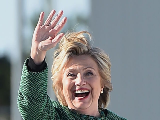 Democratic presidential nominee Hillary Clinton waves as she boards her plane October 23, 2016 at Raleigh-Durham International Airport in Morrisville, North Carolina. / AFP / Robyn BECK (Photo credit should read ROBYN BECK/AFP/Getty Images)