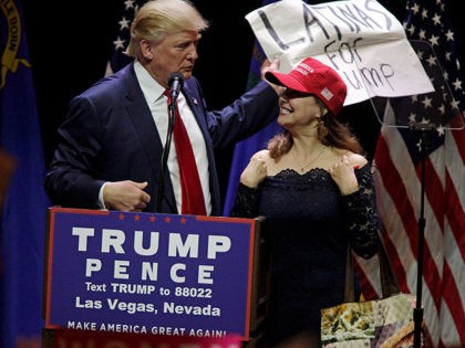 A Latino supporter speaks on stage with Republican presidential candidate Donald Trump dur