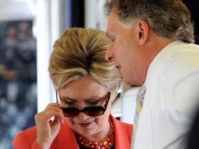US Democratic presidential hopeful New York Senator Hillary Clinton removes her sun glasses while talking with campaign chairman Terry McAuliffe as she boards her charter plane at Dulles airport outside Washington, DC on her way to Charleston, West Virginia on May 13, 2008, the day of the state's Democratic primary …