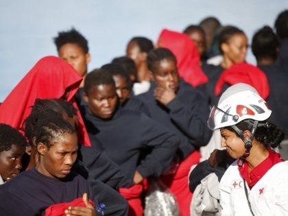 This handout picture taken and released by the Italian Red Cross on October 22, 2016 shows migrants landing in Vibo Marina, after a rescue operation in the Mediterranean Sea. Nine people drowned, ten were missing and nearly 1000 migrants were rescued off the Libyan coast on October 22, with over …