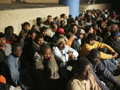 LAMPEDUSA, ITALY - JUNE 13: Illegal immigrants wait to be sent to a temporary holding cent