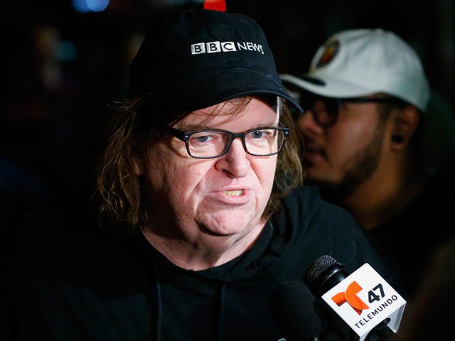 US filmmaker Michael Moore speaks with members of the media as he arrives at the IFC Theater before the debut of a surprise documentary about Republican presidential nominee Donald Trump titled 'TrumpLand' in New York on October 18, 2016. / AFP / KENA BETANCUR (Photo credit should read KENA BETANCUR/AFP/Getty …