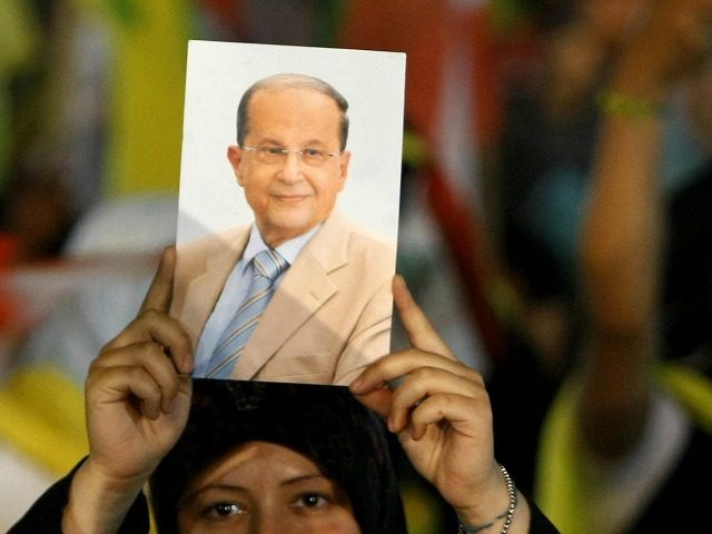 A Lebanese Hezbollah supporter holds a picture of the militant group's Christian ally, Free Patriotic Movement leader Michel Aoun, during a rally in southern Beirut on May 25, 2009 to mark the ninth anniversary of Israel's withdrawal from southern Lebanon after a 22-year occupation. Lebanon is preparing to hold parliamentary …