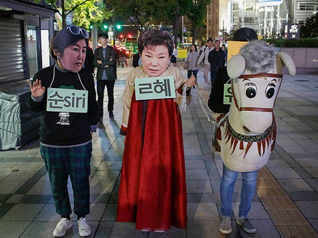 Protesters wear Park Geun Hye Mask with performance during an anti-President protest in Se