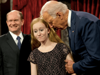 Vice President Joe Biden leans in to say something to Maggie Coons, next to her father Sen. Chris Coons, D-Del., after Biden administered the Senate oath to Coons during a ceremonial re-enactment swearing-in ceremony, Tuesday, Jan. 6, 2015, in the Old Senate Chamber of Capitol Hill in Washington. (AP Photo/Jacquelyn …