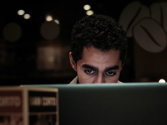 A Bahraini man browses the internet on his laptop in a coffee shop in the capital Manama o