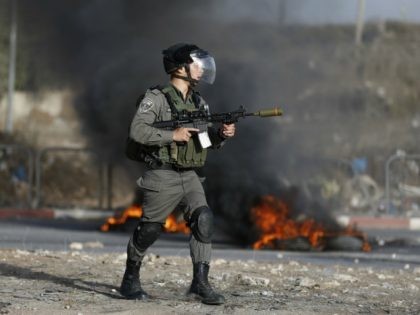 An Israeli border guard holds a rifle with a rubber bullet attachment during clashes with Palestinian youths in the West Bank town of al-Ram, north of Jerusalem, on October 9, 2016. A Palestinian opened fire from a car in Jerusalem and again as Israeli police chased him, killing an officer …