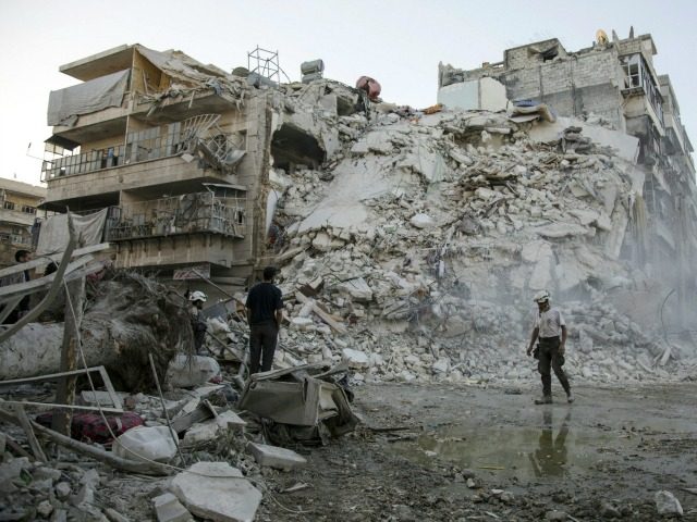 Members of the Syrian Civil Defence, known as the White Helmets, search for victims amid the rubble of a destroyed building following reported air strikes in the rebel-held Qatarji neighbourhood of the northern city of Aleppo, on October 17, 2016. Dozens of civilians were killed as air strikes hammered rebel-held …
