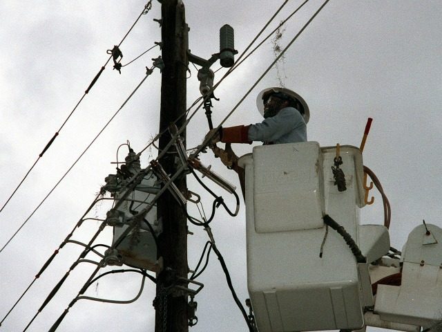 Harvey Jordan of the Florida Power and Light Company works at restoring power 15 September