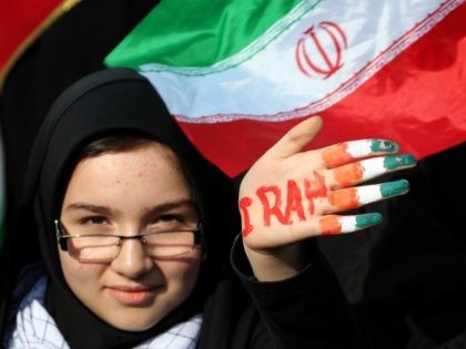 An Iranian female student holds up her hand painted in the colours of her national flag during a rally in Tehran's Azadi Square (Freedom Square) to mark the 35th anniversary of the Islamic revolution on February 11, 2014. The 35th anniversary of the revolution that ousted the US-backed shah, comes …