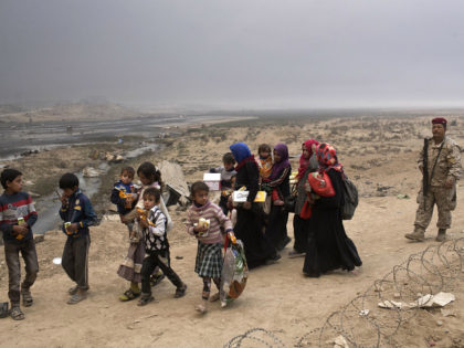 Internally displaced persons clear a checkpoint in Qayara, some 50 kilometers south of Mosul, Iraq, Wednesday, Oct. 26, 2016. Islamic State militants have been going door to door in farming communities south of Mosul, ordering people at gunpoint to follow them north into the city and apparently using them as …
