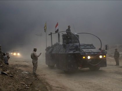 An Iraqi Federal Police vehicle passes through a checkpoint in Qayara, some 50 kilometers