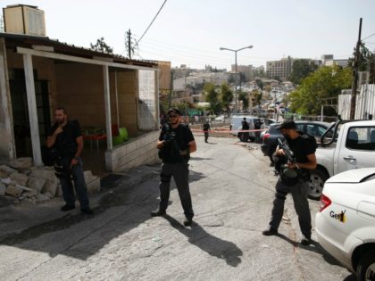 Israeli security forces stand guard at the site of a shooting attack near Israeli police headquarters in mainly Palestinian east Jerusalem on October 9, 2016. A Palestinian opened fire from a car in Jerusalem, wounding four people out of which two have died, before police shot him dead, authorities said. …