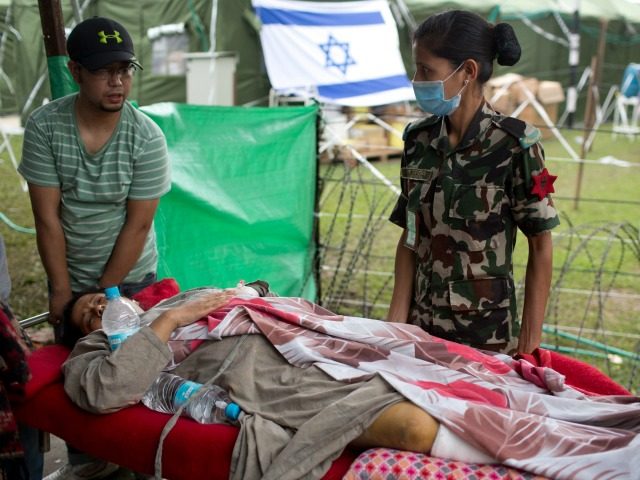 An injured Nepalese woman arrives on stretcher to be treated at the Israeli field hospital