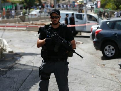 An Israeli security forces member stands guard at the site of a shooting attack near the Israeli police headquarters in mainly Palestinian east Jerusalem on October 9, 2016. A shooting attack in Jerusalem left at least three people wounded, including two seriously, with the assailant killed by police, Israeli authorities …
