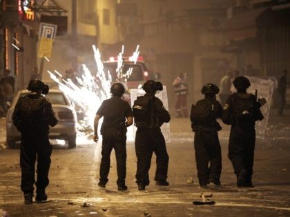 Israeli police throw grenades during clashes with Palestinians in East Jerusalem after the funeral of Palestinian teenager Mohammed Sinokrot, 16, who was wounded by Israeli gunfire on August 31 and died from his injuries on September 8, 2014. News of his death sparked widespread clashes near his home and throughout …