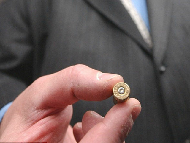 Todd Lizotte holds a cartridge case fired from a handgun marked with microstamping technol