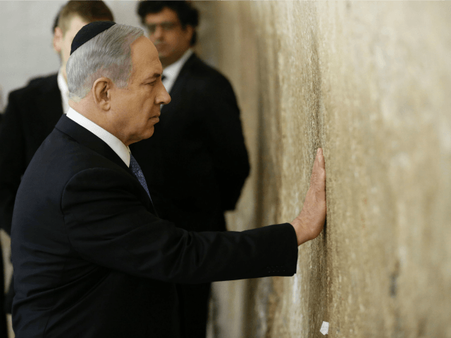 Israeli Prime Minister Benjamin Netanyahu prays on March 18, 2015 at the Wailing Wall in J