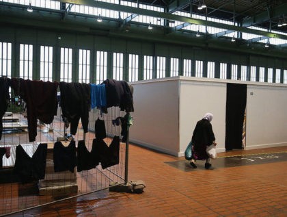BERLIN, GERMANY - FEBRUARY 11: Laundry hangs to dry in Hangar 7 where refugees and migrants seeking asylum in Germany live for now at former Tempelhof Airport on February 11, 2016 in Berlin, Germany. Tempelhof, once an airport in the city center and first built in the 1930s, now houses …
