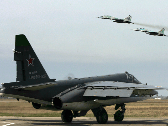 Russian SU 25 SM ground attack aircraft (ground) and MIG 29 jet fighters (taking off) attend a training session at Primorkso-Akhtarsk, Krasnodar region on March 26, 2015 ahead of the Russian commemoration of the 70th anniversary of the capitulation of Nazi Germany in 1945. AFP PHOTO / SERGEY VENYAVSKY (Photo …