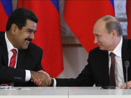Russia's President Vladimir Putin (R) and his Venezuelan counterpart Nicolas Maduro shakes