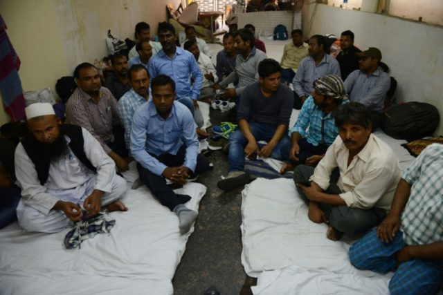 Indian workers from Bihar state gather in a New Delhi hotel after the Indian government re