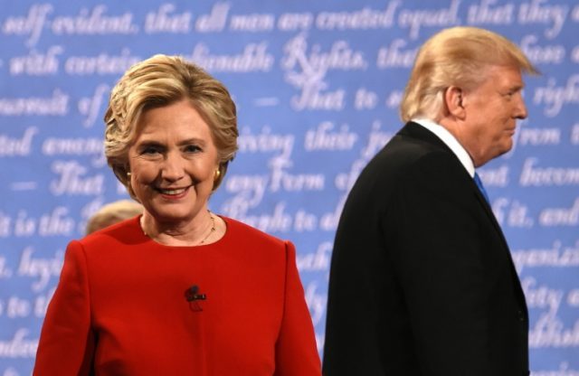 Democratic nominee Hillary Clinton (L) and Republican nominee Donald Trump leave the stage
