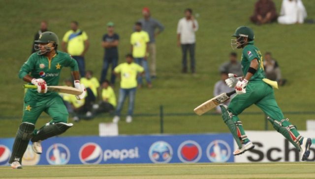 Pakistan's Babar Azam (R) and Sarfraz Ahmed run between the wickets during the third one-d