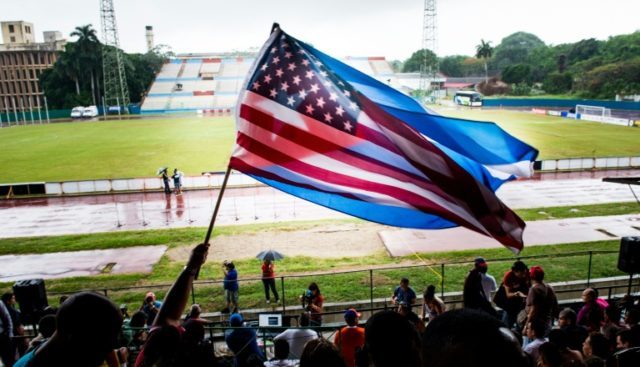Fans wave Cuban and US flags on June 2, 2015, during the friendly game in Havana between t