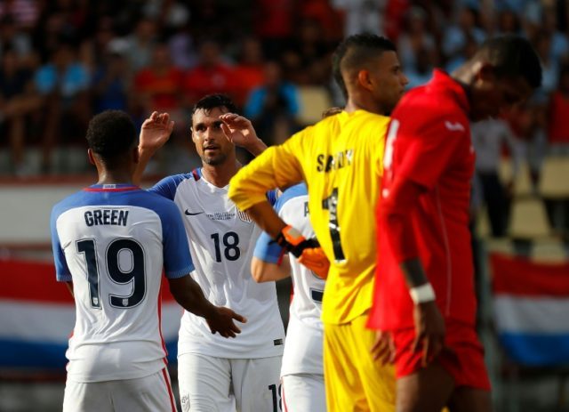 Chris Wondolowski (No. 18) of the US celebrates with teammate Julian Green after he assist