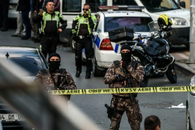 Turkish special force police officers patrol at the scene of a motor-bike bomb explosion,