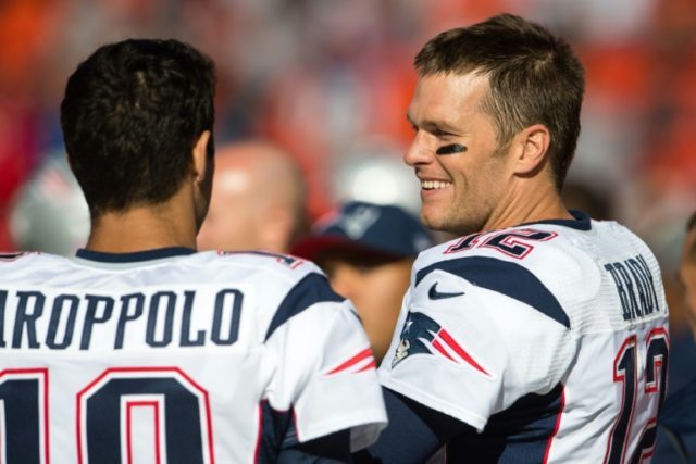 Quarterbacks Jimmy Garoppolo and Tom Brady of the New England Patriots talk on the sidelin
