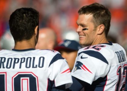 Quarterbacks Jimmy Garoppolo and Tom Brady of the New England Patriots talk on the sidelines against the Cleveland Browns, in Cleveland, Ohio, on October 9, 2016