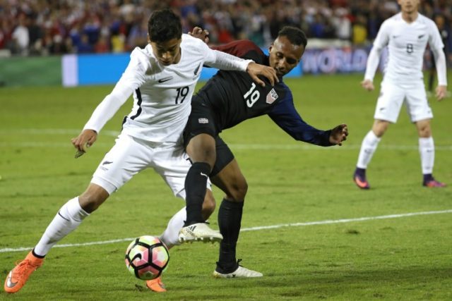Julian Green (R) of the US fights for the ball with Moses Dyer of New Zealand during their