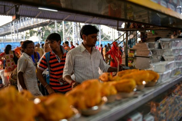 An Indian Railways employee prepairs food at the food stall on a platform inside the Mathu