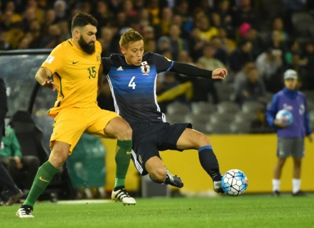 Japan's Keisuke Honda (right) battles for the ball with Australia's Mile Jedinak during a