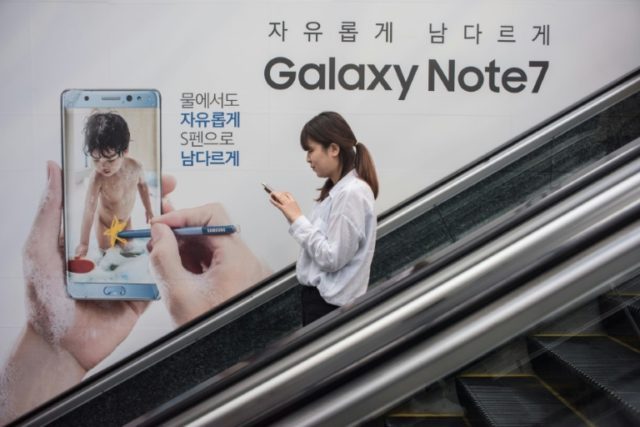 A woman passes an advertisement for Samsung's Galaxy Note 7 device in the Gangnam district