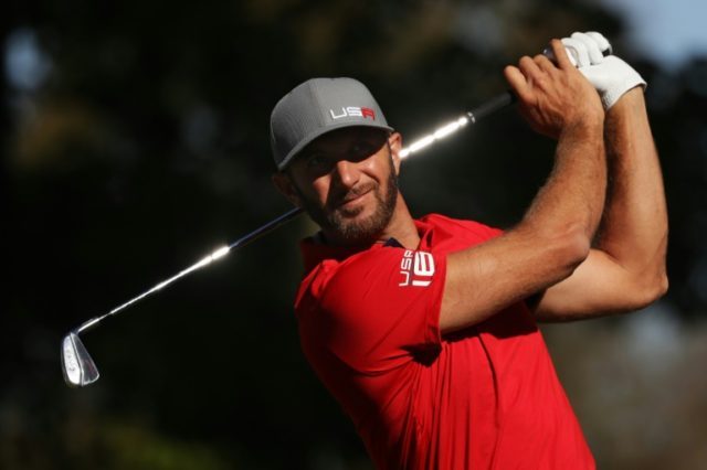 Dustin Johnson of the United States hits off the 13th tee during morning foursome matches