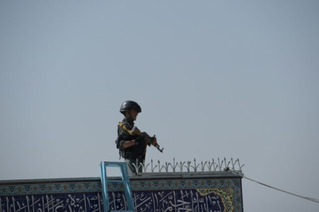 A policeman keeps watch inside the Karte Sakhi shrine in Kabul on October 12, 2016, after