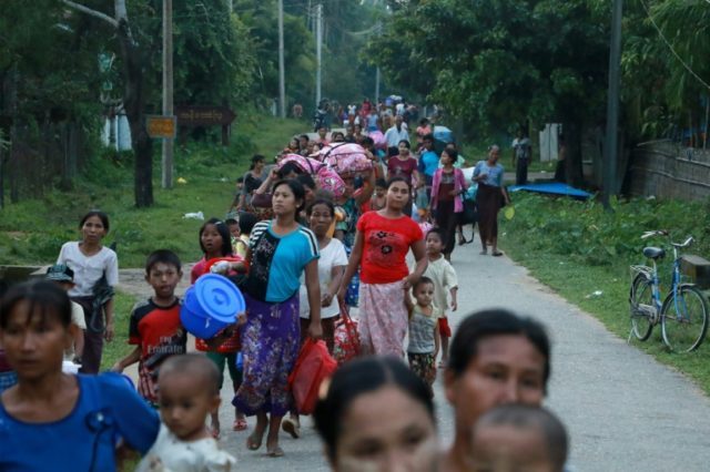 Residents displaced by conflict flee from Maungdaw in Rakhine State on October 13, 2016