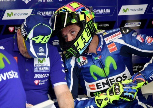 Valentino Rossi speaks to his mechanic during the first MotoGP-class free practice at the
