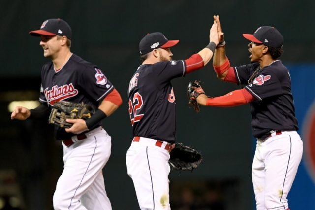 Francisco Lindor (R) of the Cleveland Indians celebrates with teammates after defeating th