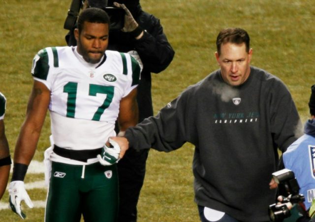 Honorary captin Dennis Byrd of the New York Jets (R) walks off the field with Braylon Edwa