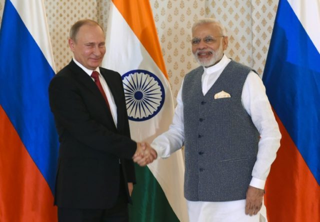 Indian Prime Minister Narendra Modi (right) shakes hands with Russian President Vladimir P